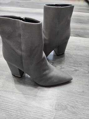 Calvin Klein Minna ankle booties featuring a block heel and pointed toe design